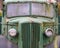 Front view of an old abandoned green rusty 1940s truck