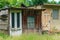 Front view of old garden sheds on sunny day