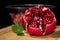 Front view of opened pomegranate with mint leaves and bawl of seeds