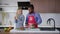 Front view portrait of cheerful Caucasian woman taking apple as African American man in apron cutting salad ingredients