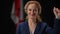 Front view portrait of confident smiling inspired woman showing support strength gesture looking at camera. Canadian