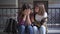 Front view portrait of empathetic teenage girl calming down friend crying sitting outdoors. Supportive Caucasian girl