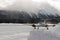 A front view of a private jet ready to take off in the snow covered landscape and mountains in hte alps switzerland in winter