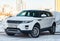 Front view of Range Rover Land Rover Evoque in white color after cleaning before sale in a winter day and snow background