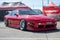 Front view of a red classic Japanese sports car Nissan Silvia S13 parked on the street