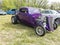 Front view of a restored purple circa 1932 vintage ford deuce coupe