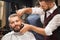 Front view of satisfied male in barber shop getting haircut