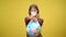 Front view serious female adolescent eco-activist looking at camera stretching Earth globe in plastic bag. Portrait of