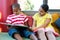 Front view of siblings reading book at home