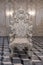 Front view of single ancient sculptures of stone chair in antique decorated room