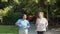 Front view of smiling women running along path in public park