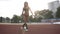 Front view of sporty woman in black bikini making lunges exercise and sit-ups on outdoors stadium. Summer time, sun