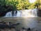 Front view, Sri Dit Waterfall is a small and forested one level waterfall with sunlight at Khao Kho, Phetchabun Province, Thailand