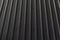Front view of straight lines on black corrugated surface.
