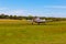 The front view of the tail, body, wings, nose and propeller of Piper PA-25 Pawnee tow aircraft  on  the ground.