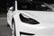 Front view of Tesla electric car. Design, exterior and appearance of white electric car of Tesla Motors automotive company