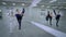 Front view three confident talented ballerinas rehearsing leg up in fifth position turning repeating movement looking at