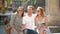 Front View of Three Happy Friends Taking Selfie Using Smartphone Outdoors on the City Square During Sunny Summer Day