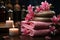 A front view of tranquil wellness ambiance, spa stones, pink flowers, towels