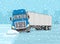 Front view of a truck skidded across the icy road. Blue semi-truck loses control and gets stuck at the edge of the road.