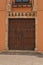Front view of a two vintage, wood, artisan, handmade doors to a winery in Spain