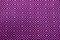 Front view of vibrant purple and black ethnic pattern fabric for background