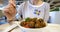 Front view of woman eating delicious meatballs at the Ikea Food restaurant