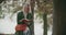 Front view of a woman swinging while reading a book under a tree in an autumn day. slow motion