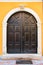 Front view of a wooden antique door, part of an antique building