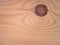 Front view of a wooden board with drawings of the grain forming waves and a large knot in the shape