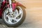 Front wheel of sports motorcycle on road. Motorbike parked on a