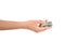 In front of a white background, one hand is holding Korean won banknotes and doing the gesture of giving