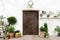 Front wood door and garden decor in white cosy house or cottage.