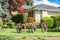 Front yard in residential community creatively landscaped with old horse vehicle