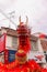 A frontal closeup from the head of a long red dragon in low angle view