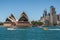 Frontal Closeup of Opera House with boats and skyscrapers, Sydney, Australia
