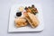 Frontal Hero shot of a breakfast platter with grilled chicken panini sandwich with olives, cheese & vegetables- carrot,