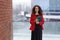 Frontal portrait of a woman, working, real estate agent, making notes on the agenda, over outside, building background.