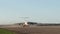 A frontal shot of an airport landing strip with a plane, going down, landing and riding towards the camera. big airplane landing a