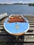 Frontal view of a traditional blue fishing boat. Moored in rusty wooden jetty vertical of the Caribbean Sea. Martinique, French