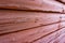Frost covered cedar red stained wood showing textures and patterns