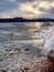 Frost crystal border between floe and dark water on lake. Natural view