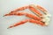 frosted Alaska king crab legs closeup photo on white table background