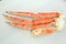 frosted Alaska king crab legs closeup photo on white table background