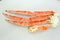 frosted Alaska king crab legs closeup photo on white table background