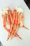 frosted Alaska king crab legs closeup photo on white table background