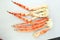 frosted Alaska king crab legs closeup photo on white table background