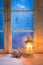 Frosted blue window with candle for Christmas