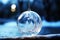 Frosted Christmas bauble, glass ball on winter background