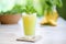 frosted glass of pineapple juice with a sprig of mint on top